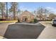 Exterior shot of a clubhouse with stone accents and ample parking spaces at 43 New Rhododendron, Chapel Hill, NC 27517
