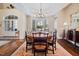 Elegant dining room with hardwood floors, chandelier, and bay window with plantation shutters at 43 New Rhododendron, Chapel Hill, NC 27517