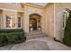 Inviting entryway with stone archway, decorative plants, and a paneled front door at 43 New Rhododendron, Chapel Hill, NC 27517