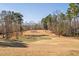 Scenic view of golf course with green and fairway surrounded by trees at 43 New Rhododendron, Chapel Hill, NC 27517