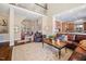 Open-concept living room featuring a fireplace, wood floors, and comfortable leather seating at 43 New Rhododendron, Chapel Hill, NC 27517