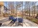 Cozy patio with blue Adirondack chairs, stone pillars, and views of wooded area at 43 New Rhododendron, Chapel Hill, NC 27517