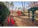 Bright community playground with slides, climbing structures, and a red park bench at 43 New Rhododendron, Chapel Hill, NC 27517