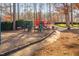 Community playground with slides, climbing structures, benches and a paved walking path at 43 New Rhododendron, Chapel Hill, NC 27517