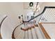 Elegant spiral staircase with black railings, hardwood accents, and modern chandelier at 43 New Rhododendron, Chapel Hill, NC 27517