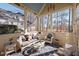 Cozy sunroom featuring comfortable seating and a view of the wooded backyard at 43 New Rhododendron, Chapel Hill, NC 27517