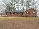 Cozy brick ranch with red shutters and a well-maintained lawn at 431 Mattox St, Wendell, NC 27591