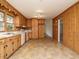 Spacious kitchen features wood paneling, ample cabinetry, and durable tiled floors for a classic look at 431 Mattox St, Wendell, NC 27591