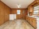 Bright kitchen showcases wood-paneled walls, plentiful storage, and easy-to-clean tiled flooring at 431 Mattox St, Wendell, NC 27591