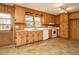Charming kitchen with vintage wood cabinets, functional appliances, and durable tiled flooring at 431 Mattox St, Wendell, NC 27591