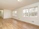 Bright living room with light-colored walls, light-colored floors, and large windows at 431 Mattox St, Wendell, NC 27591