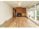 Inviting living room with a fireplace, built-ins, and bright windows, enhanced by wood laminate flooring at 431 Mattox St, Wendell, NC 27591