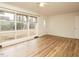 Sun-drenched living area with a wall of windows and new wood laminate flooring for a modern touch at 431 Mattox St, Wendell, NC 27591