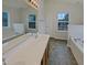 This bathroom boasts a double sink vanity, soaking tub, and plenty of natural light at 4900 Alenja Ln, Raleigh, NC 27616