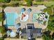 Aerial view of community pool with slides, umbrellas, and pool house at 501 Skygrove Dr, Holly Springs, NC 27540