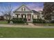 Charming home with a red door, white pillars, black shutters and well-manicured landscaping at 501 Skygrove Dr, Holly Springs, NC 27540