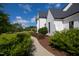 Exterior view of home's side and manicured landscaping that includes various green bushes and a mulch bed at 5137 Avalaire Oaks Dr, Raleigh, NC 27614