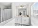 Bathroom with a double vanity, white cabinetry, a large mirror, natural light, and a view to shower at 547 Gateway Townes Blvd, Wake Forest, NC 27587