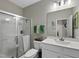 This bathroom features tile floors, a shower, and a sink with white cabinets and silver hardware at 547 Gateway Townes Blvd, Wake Forest, NC 27587