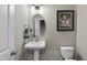 Chic half-bath with a pedestal sink and modern accents at 547 Gateway Townes Blvd, Wake Forest, NC 27587