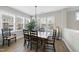 Bright dining room with large windows and a rustic wooden dining set at 547 Gateway Townes Blvd, Wake Forest, NC 27587