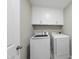 Well-lit laundry room featuring white cabinets, Samsung washer and dryer, and patterned tile floors at 547 Gateway Townes Blvd, Wake Forest, NC 27587