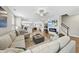 Bright living room features an electric fireplace and flows into the modern kitchen at 547 Gateway Townes Blvd, Wake Forest, NC 27587