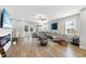 Open concept living room with fireplace, large sectional couch and doors to outdoor deck at 547 Gateway Townes Blvd, Wake Forest, NC 27587