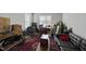 Music room featuring hardwood floors, Persian rug, recording equipment, and black leather couch at 547 Gateway Townes Blvd, Wake Forest, NC 27587