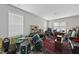 Spacious music room featuring drum set, Persian rug, recording equipment, and black leather couch at 547 Gateway Townes Blvd, Wake Forest, NC 27587