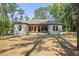 Spacious backyard with a covered patio and lush greenery, perfect for outdoor entertaining and relaxation at 5750 Nc Highway 49, Burlington, NC 27215