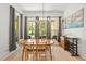 Bright dining room featuring a wooden table, neutral decor, and a large window with backyard views at 5750 Nc Highway 49, Burlington, NC 27215