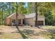 Inviting brick home surrounded by mature trees and a well-manicured lawn at 5750 Nc Highway 49, Burlington, NC 27215