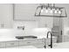 Bright kitchen featuring white cabinets, subway tile backsplash, quartz countertop, and stainless steel appliances at 5750 Nc Highway 49, Burlington, NC 27215