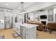 Kitchen with white cabinets, stainless steel appliances, island with a farmhouse sink, and an open concept living room at 5750 Nc Highway 49, Burlington, NC 27215
