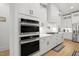 Bright kitchen featuring white cabinets, subway tile backsplash, quartz countertop, and stainless steel appliances at 5750 Nc Highway 49, Burlington, NC 27215