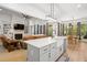 Open concept kitchen features a large island with a farmhouse sink and views to the living and dining rooms at 5750 Nc Highway 49, Burlington, NC 27215