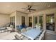 Covered outdoor patio with brick walls, ample seating, and a ceiling fan at 5750 Nc Highway 49, Burlington, NC 27215