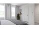 Bright bedroom featuring modern decor, white walls, and a view of the entry door at 681 Mirkwood, Apex, NC 27523