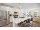 Bright, open kitchen with stainless steel appliances and quartz island with seating at 681 Mirkwood # 99, Apex, NC 27523