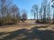 Expansive backyard featuring a small pond, mature trees, and open space at 7027 Old 421 Rd, Liberty, NC 27298