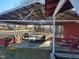 A barn with a silver tin roof, trailer, and red benches at 7027 Old 421 Rd, Liberty, NC 27298