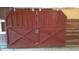 Sturdy red barn doors provide secure access to the horse barn at 7027 Old 421 Rd, Liberty, NC 27298