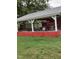 A red barn area with a silver tin roof and open area to store a trailer at 7027 Old 421 Rd, Liberty, NC 27298