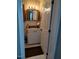 Bathroom with vanity and mirror, accentuated by white beadboard paneling at 7027 Old 421 Rd, Liberty, NC 27298