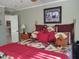 Cozy bedroom features decorative quilt bedding and warm, inviting decor at 7027 Old 421 Rd, Liberty, NC 27298