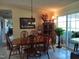 Elegant dining room with a wood table, chairs, natural lighting, and views of the outdoors at 7027 Old 421 Rd, Liberty, NC 27298