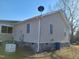 Home exterior featuring durable siding, efficient generator, and well-maintained landscaping at 7027 Old 421 Rd, Liberty, NC 27298