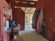 View inside the horse barn featuring stalls, storage, and access to the outdoors at 7027 Old 421 Rd, Liberty, NC 27298