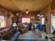 Comfortable living area with rustic wood walls and a window bringing in natural light at 7027 Old 421 Rd, Liberty, NC 27298